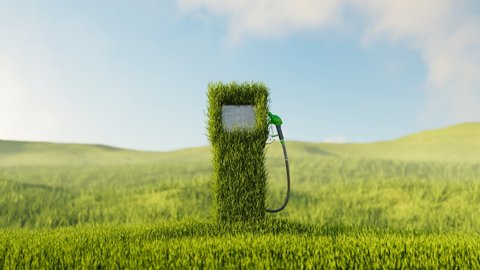 Fuel dispenser with a gas pump nozzle covered by green grass. Concept of eco-friendly fuels for transportation and renewable energy sources. Biodiesel. Refuel car with eco petrol at the gas station.