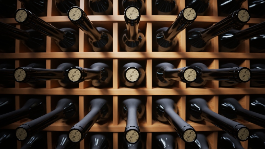Seamless looping animation of wine bottles ordered on wooden shelves in a dark wine cellar. Concept of traditional winemaking in the winery. Large storage of wines in vineyard or restaurant. | Shutterstock HD Video #1081258586