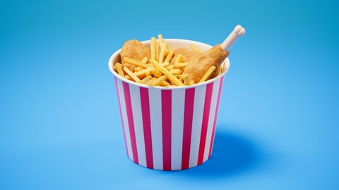 Delicious and crispy fried chicken with french fries in a red and white striped paper bucket. Fast food. Hot and tasty meal. Chicken wings, and legs with chips. Crunchy salty snack. Junk food.