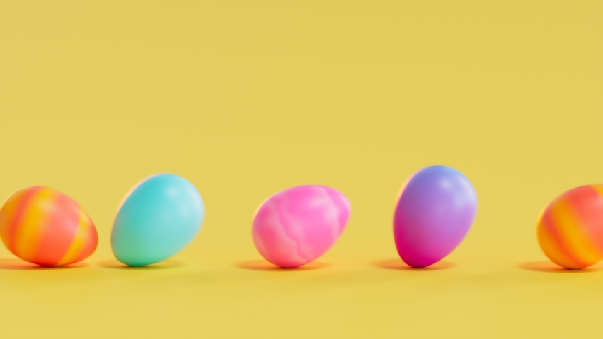 Seamless looping animation of multicolour Easter eggs on a yellow background. Happy Easter. A row of eggs rolling in one direction. Concept of traditional spring celebration. Symbol of new life. Royalty-Free Stock Footage #1081259198
