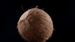 Video of rotating coconut on black background