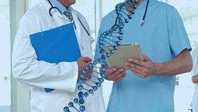 Animation of dna strand spinning over doctors using tablet. global medicine, technology, data processing and digital interface concept digitally generated video. - Powered by Shutterstock - Get 15% off with code: PIKWIZARD15