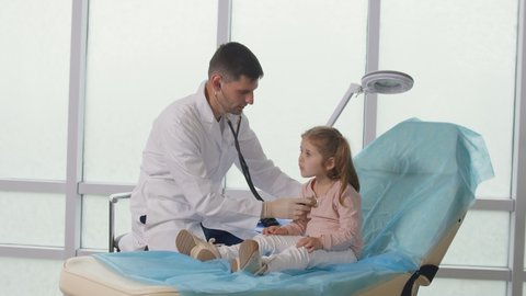 Child Patient Visits the Doctor'S Office. The Doctor Listens to the Lungs of the Child With a Stethoscope, Speaks Caringly with the Little Girl. Comfortable Stay of the Child in the Clinic.