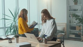 Two Girl Students Study Online Together, Attend an Online Class, Take Notes Using a Tablet, a Computer in a Cozy Room. College Life. The Concept of Modern Online Education. Mental Health.
