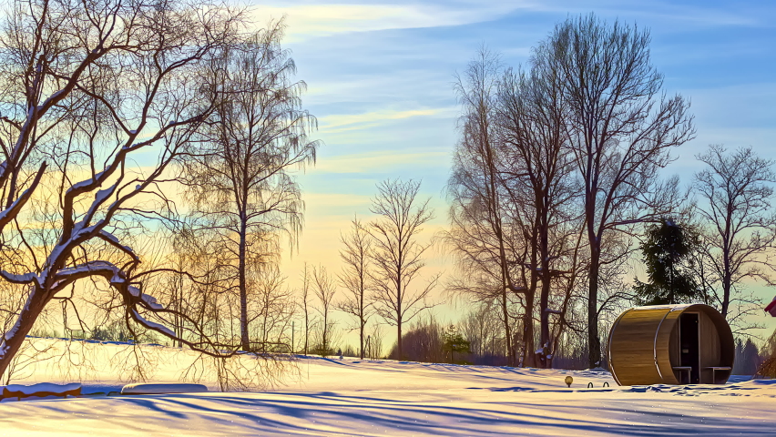 Spectacular time lapse of sunset with flying colorful cloudscape at sky, sun lighting on snowy winter landscape with barrel sauna in foreground - Cinematic prores high quality shot
