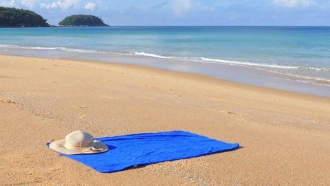 Morning air of beautiful Phuket Thailand beaches. There was a blue towel on the beach. stork foraging for food