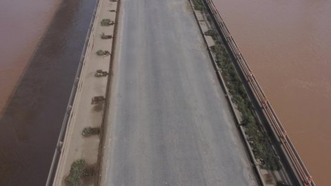 Bharuch, Gujarat  India - Oct 02, 2021: Aerial drone view of national highway 
48 of golden quadrilateral. Trucks, cars slow down at toll booths and potholes. A long queue of traffic is seen. 