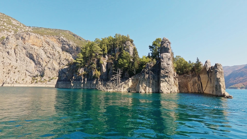 Panorama landscape of lake with turquoise water and  stone sharp rocks.