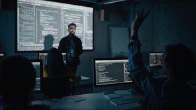 Teacher Giving Computer Science Lecture to Diverse Multiethnic Group of Female and Male Classmates in Dark College Room. Student Raises Hand and Answers Lecturer a Question About Software Engineering. - Powered by Shutterstock - Get 15% off with code: PIKWIZARD15