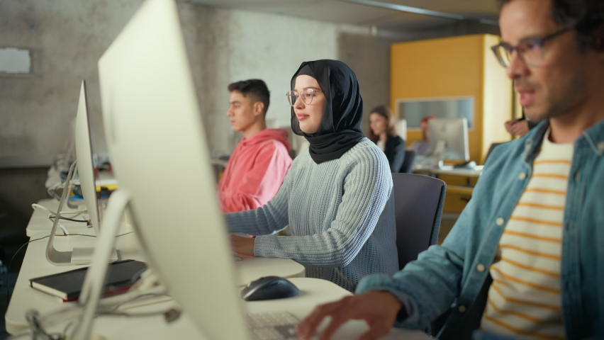 Female Muslim Student Wearing Hijab, Studying in Modern University with Diverse Multiethnic Classmates. She Asks Scholar a Question in College Room. Lecturer Shares Knowledge with Smart Scholars. Royalty-Free Stock Footage #1081280498