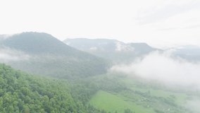 Aerial video of clouds, mountains, forest and mountain river