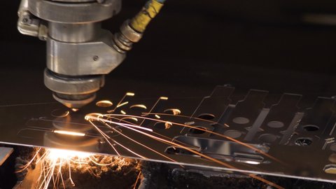High precision cutting machine metal part. Modern machine laser metal sheet cnc cutting steel plate. Burn laser cutter work steel products. Metalwork. Automated machine CNC laser cutting metal plate