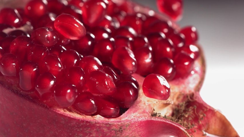 Pomegranate Grains rolls down on surface of broken pomegranate in slow motion | Shutterstock HD Video #1081291577