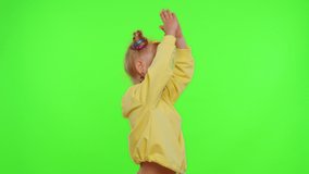 Happy funky young female blogger child kid girl, recording funny dancing video on smartphone for social network or personal channel, having fun entertaining on weekend at home on chroma key background