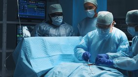 Multiracial team of professional medical surgeons performs the surgical operation in a modern hospital. Doctors are working to save the patient. Medicine, health, cardiology and transplantation. - Powered by Shutterstock - Get 15% off with code: PIKWIZARD15