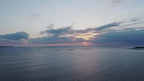 Aerial video on Jimbaran beach, Bali island. Orange and Pink sunset