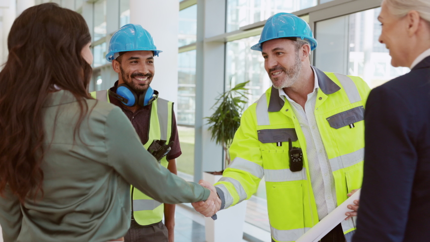 Smiling civil engineer and manual worker shaking hands at construction site with happy business women. Construction manager and supervisor shaking hand on building site. Team of workers meeting. | Shutterstock HD Video #1081307792