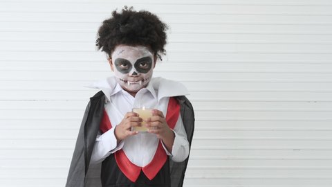 Little black skinned boy in dracula costume looking at camera. African american child in halloween festival concept.October event. 