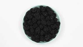 Blackberries on a plate. Top view. Loop motion. Rotation 360. 4K UHD video footage 3840X2160.