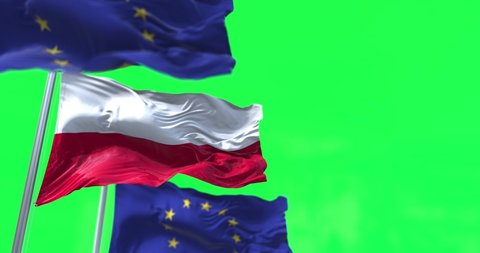 The flags of Poland and the European Union waving in the wind with green screen in the background. On October 2021 polish Constitutional Tribunal issued that the Polish Constitution in some cases supe