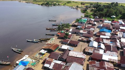 Aerial coastal rural ocean fishing village Liberia. West Africa historical country with dark history Civil wars, Ebola and COVID and economic failures stagnated economic growth.