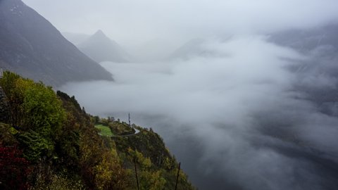 Clouds and Fog Over Geirangerfjord And Mountains From Ornesvingen Viewpoint In Norway. - timelapse