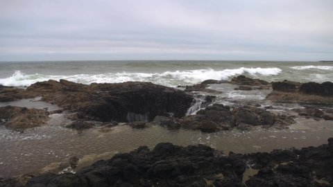 The magnificent Thors Well during a rough and stormy sea at high tide on the Oregon Coast.