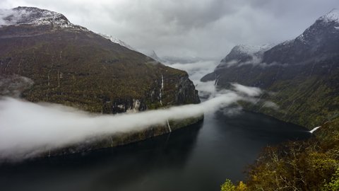 Clouds Moving Over Geirangerfjord Between Mountains With Waterfalls From Ornesvingen Viewpoint In Norway. - hyperlapse, zoom in