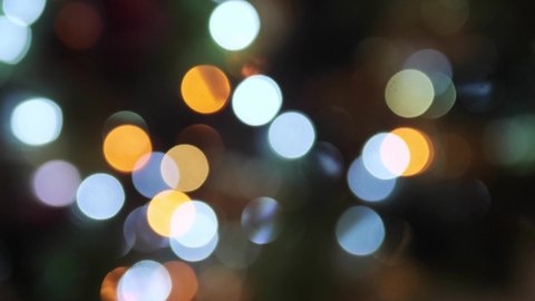 Blurred Christmas lights. Glitter bokeh of Christmas tree. Abstract blurred lights Christmas Tree bokeh background, defocused lights.