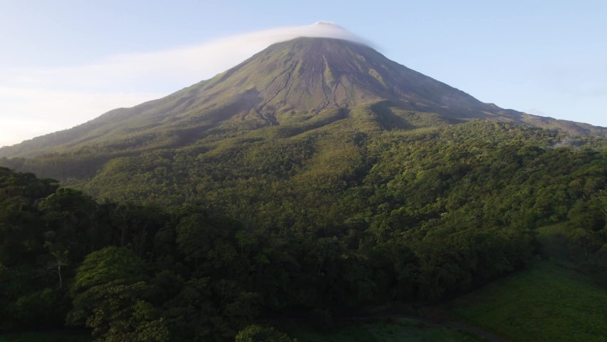 Cinematic Aerial Drone View of Mountain Arenal in Costa Rica with Beautiful Forest and cloud formations around majestic environment Royalty-Free Stock Footage #1081325504