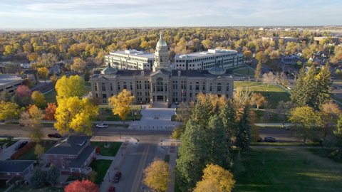 Aerial footage of Wyoming State Capitol building in Cheyenne. Drone shot circling the statehouse at sunset.