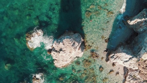Beautiful rocks on the beach, Elba Island overhead view, Italy. Slow motion