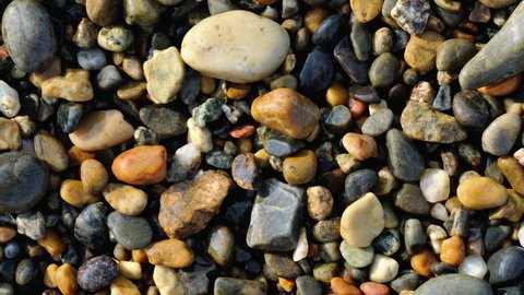seaside wet pebbles background close up