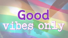 Animation of good vibes only text over rainbow flag and couple holding hands. lgbtq pride and equality celebration concept digitally generated video. - Powered by Shutterstock - Get 15% off with code: PIKWIZARD15