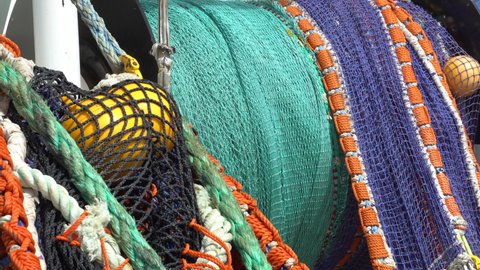 Removing a trawl on a fishing vessel. Close-up. The fishing net is wound on a drum.