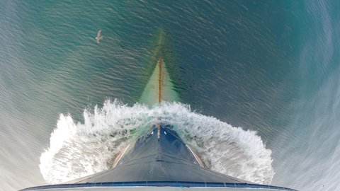 View from above. The bow of the ship is cut by the waves of the calm northern sea.