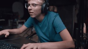 Caucasian Young Teen Guy Plays Games On Computer And Streams The Games Live