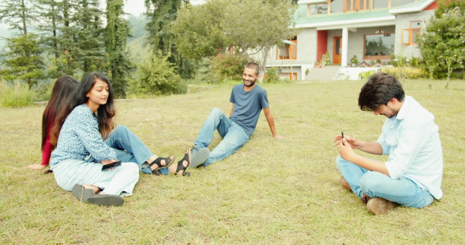 An Indian friends spending time together in a garden taking pictures