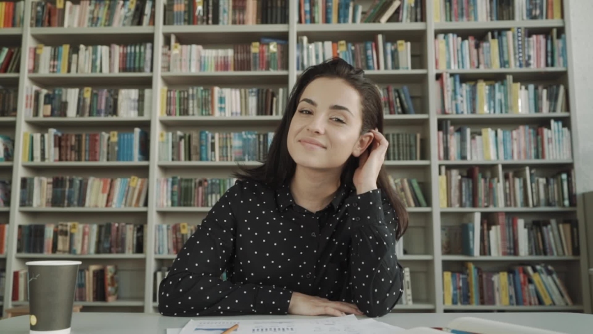 web view of beautiful young brunette woman, female happy and smiling looking at camera