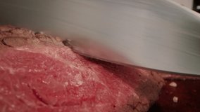 Closeup Of Unrecognizable Cook Cutting Red Meat With Kitchen Knife Preparing Beef Steak Indoors. Cropped Shot. Tasty Beef Steak Recipe, Healthy Food Preparation Concept