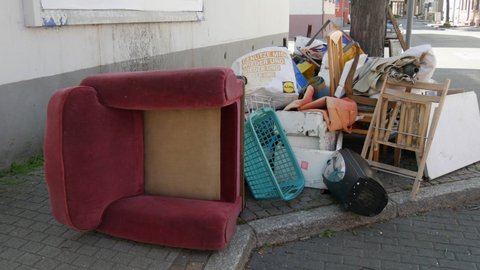April 27, 2021 - Kehl, Germany: Large heaps of household rubbish, furniture, belongings, household items lie on street before it is removed by garbage truck. Once a year, people throw unwanted items