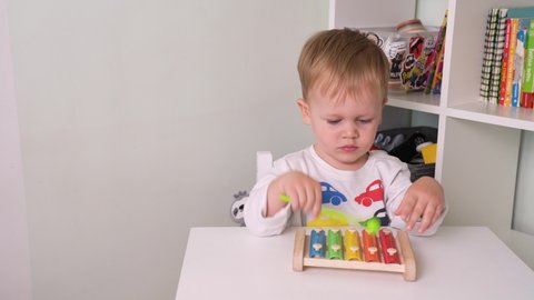 Little Kid In Kindergarten Playing Xylophone