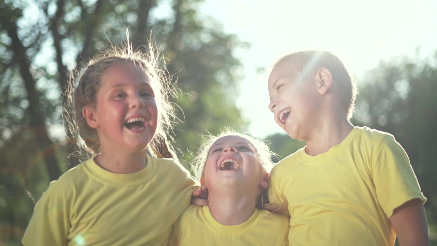 Happy family of children. Children in forest park play laughing. Happy kid smiles together for camera in forest park. Teamwork of kid. Play in forest park. Smiles of children. Happy teamwork concept. Royalty-Free Stock Footage #1081377983