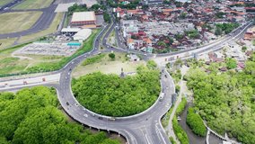 Aerial footage roundabout near to International Airport on Bali. Top down static view to busy traffic. High quality 4k video
