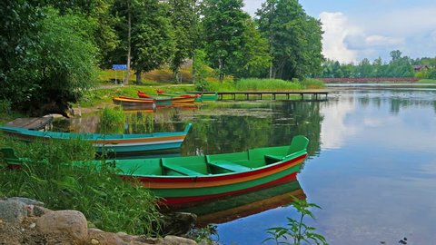 Multicolored picturesque wooden boats moored on lake shore, Trakai, Lithuania.