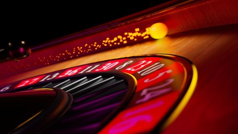 Close up shot of a spinning roulette. Presentation of a luxury casino roulette wheel with a yellow spinning fireball. Polished, elegant roulette with golden elements in Las Vegas. Gambling. Lucky game