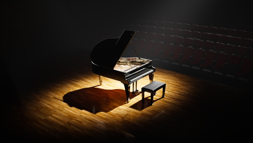 Luxurious grand piano standing on a stage in a big concert hall. Perfect black glossy paint shines in a stage spotlight. Classical instrument ready to perform for talented musicians. Passion for music Royalty-Free Stock Footage #1081384136