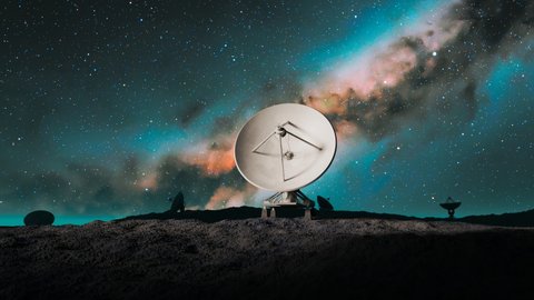 A satellite dish on the top of the hill at night. Space observatory signal search. Radio astronomy observatory. Amazing night sky landscape with antenna silhouettes. Discovery, science, technology.