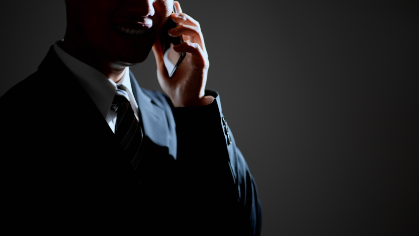 Male image of a scammer making a phone call Royalty-Free Stock Footage #1081389167