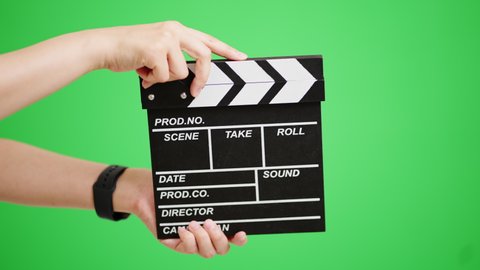 Chroma key composite image of the arm that rings the clapperboard